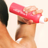 Man holding the Bacne Spray behind his shoulder