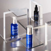 Vitamin C serum bottles among clear acrylic blocks