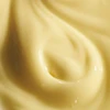 Close-up of creamy pale yellow emulsion texture