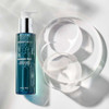 Cleanser bottle beside clear glass dishes