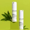 Two Replenix Pigment Correcting Brightening Cream bottles on a green backdrop with leaves