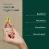 Hand holding a capsule with beet root, maca, carrot and spinach ingredient list