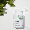 Thorne L-Glutamine bottle among leaves with a 0.854 inch capsule size marker