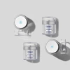 Four ELASTIderm jars, open and closed, on a gray background
