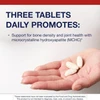 Hand holding tablets, three tablets daily graphic