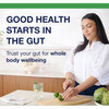 Woman preparing vegetables with gut health message