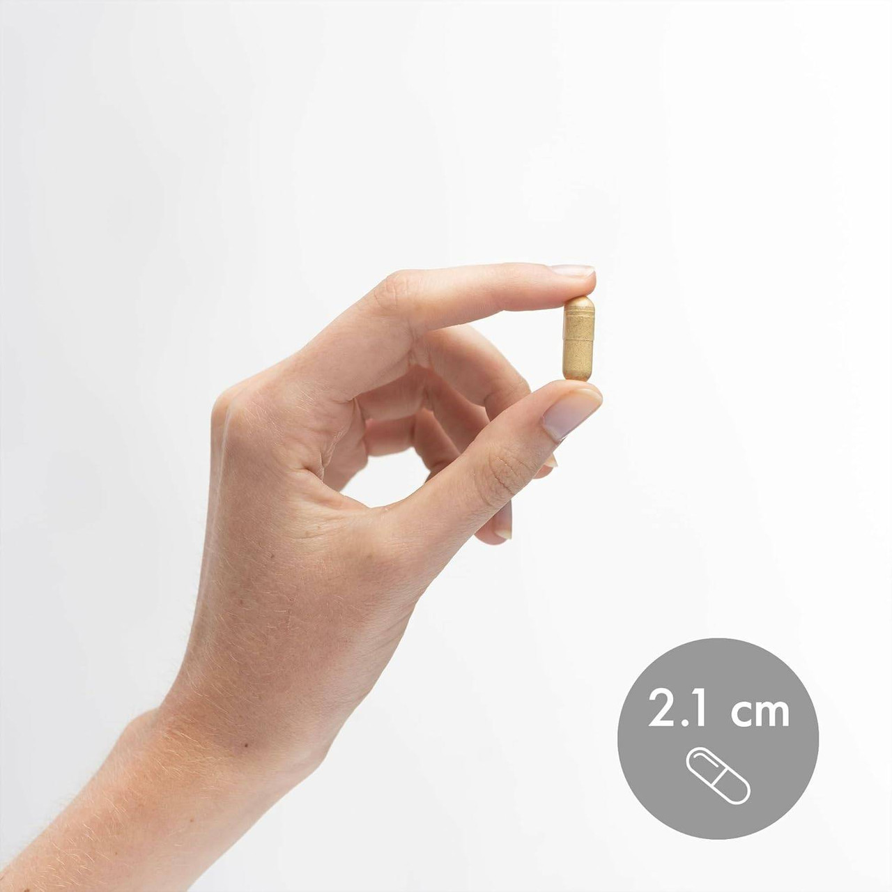 Hand holding a 2.1 cm capsule