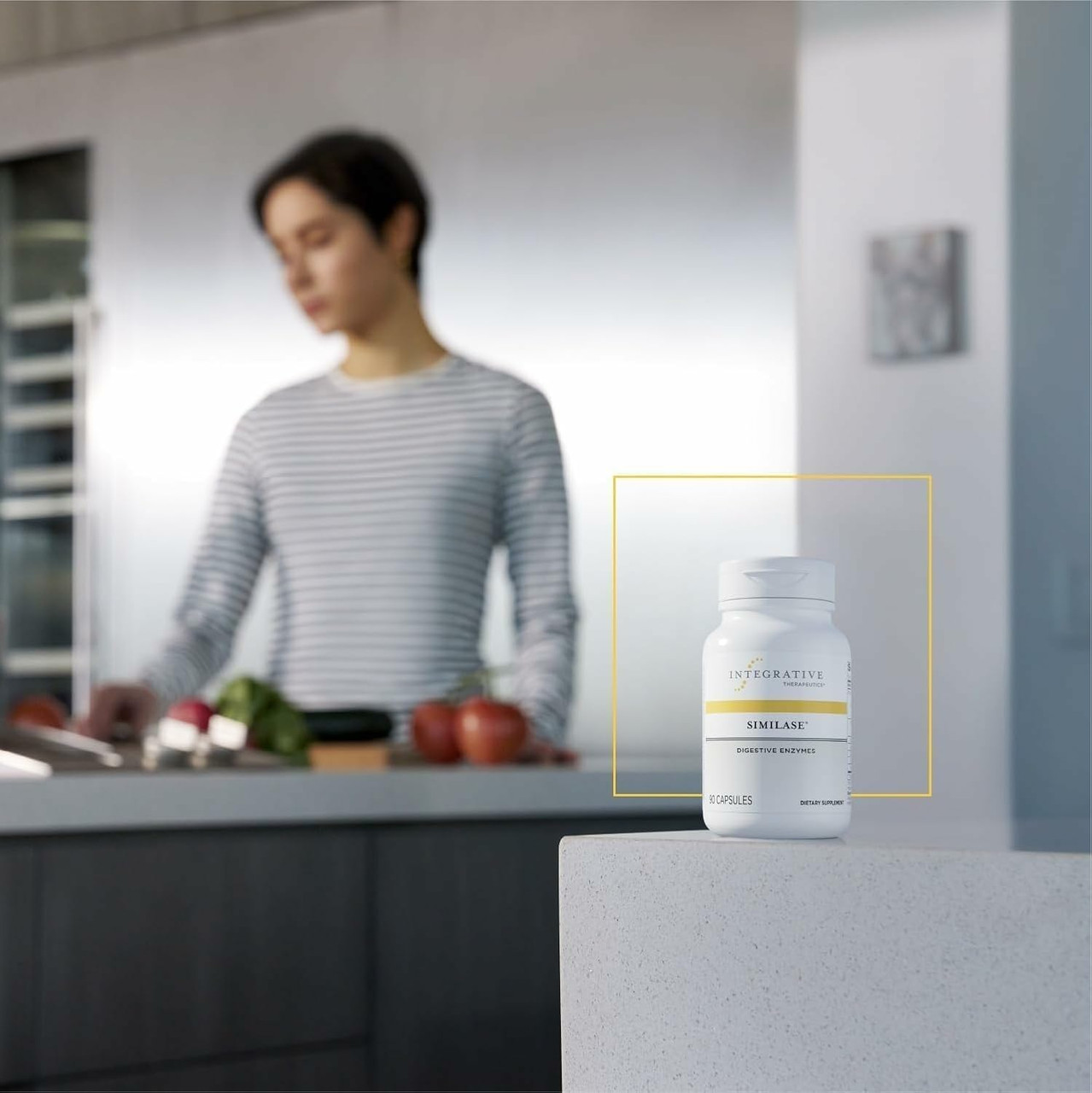 Man cooking in a kitchen beside an Integrative Therapeutics bottle