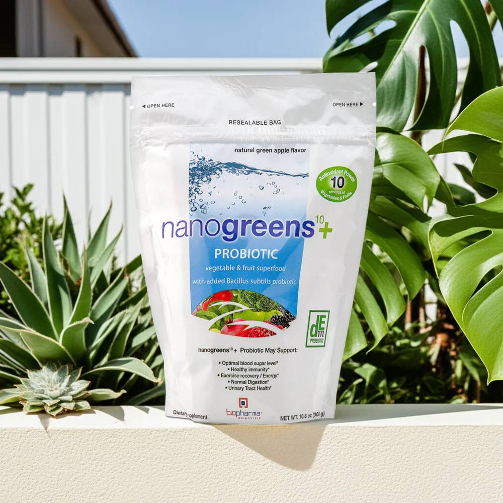 NanoGreens Plus green apple pouch on a ledge beside a succulent