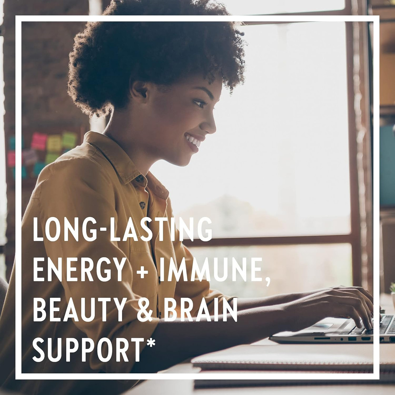 Woman smiling at a laptop, long-lasting energy immune beauty brain support graphic