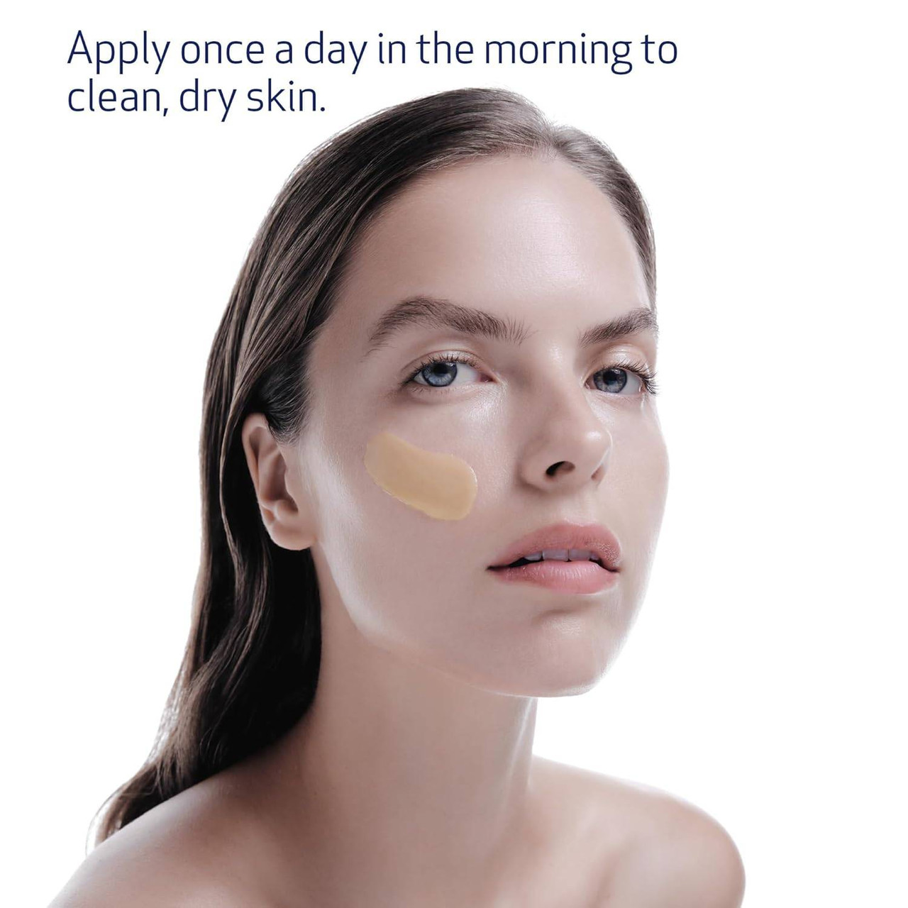 Woman with a drop of serum on her cheek and morning use directions