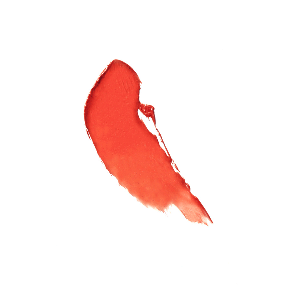 Swatch of bright coral Youngblood Lipstick