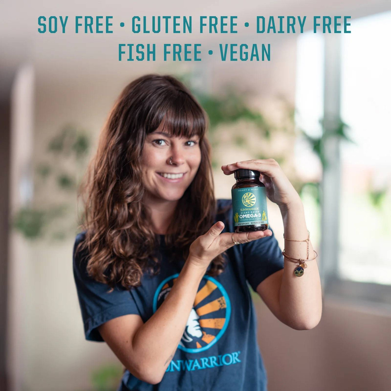 Woman holding Omega-3 bottle, soy gluten dairy fish free vegan icons