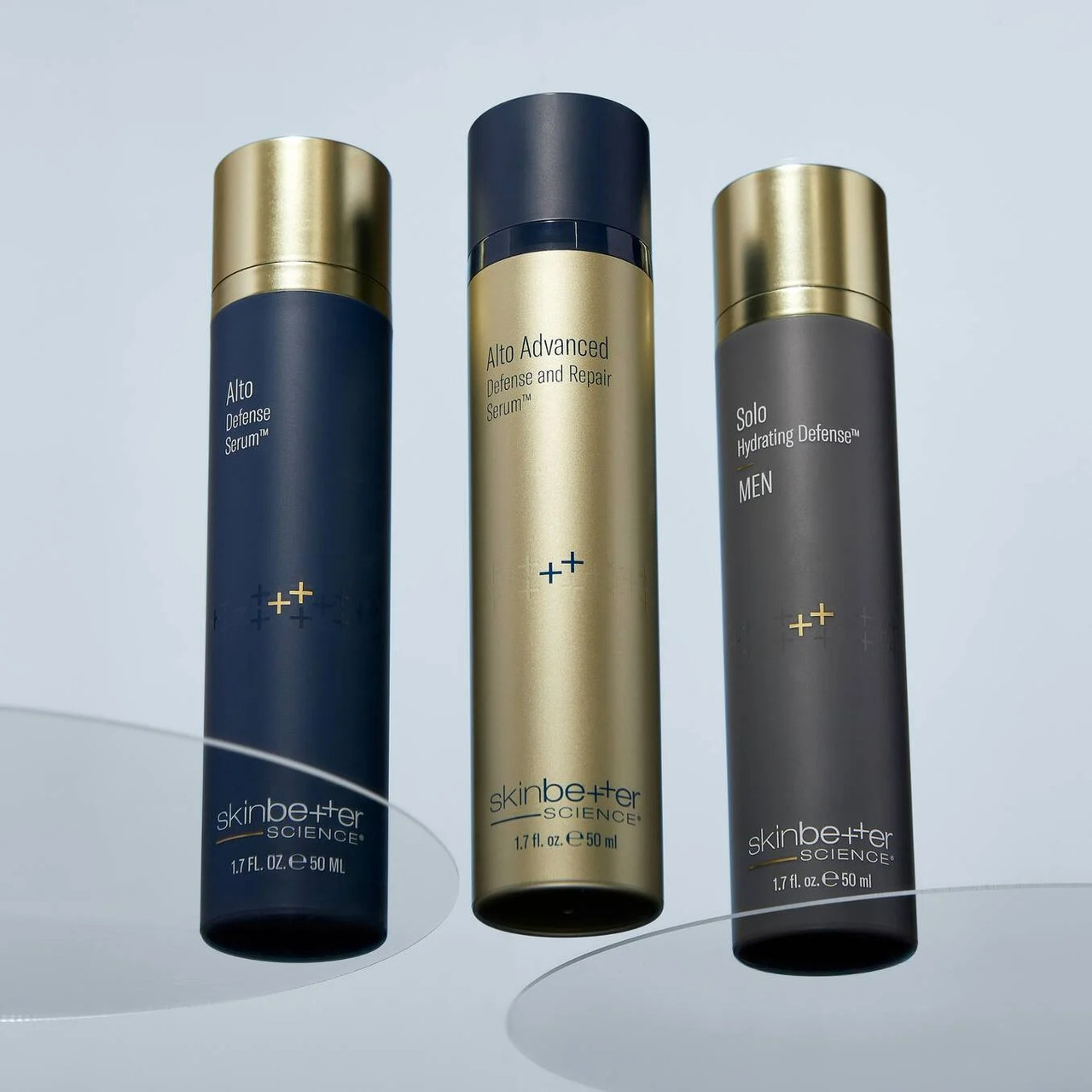 Three Skinbetter Science bottles on a reflective surface