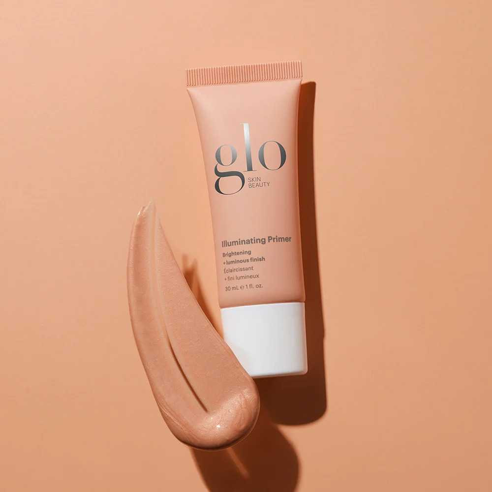 Illuminating Primer tube beside luminous peach cream smear