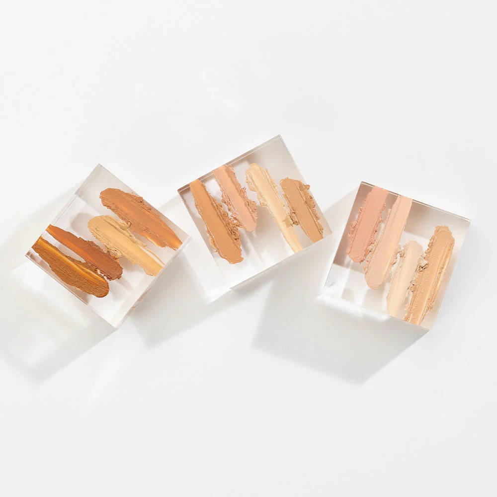 Concealer smears on three clear acrylic blocks