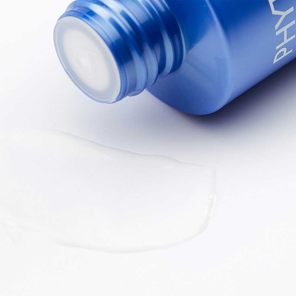 Body milk bottle tipped over a pool of lotion