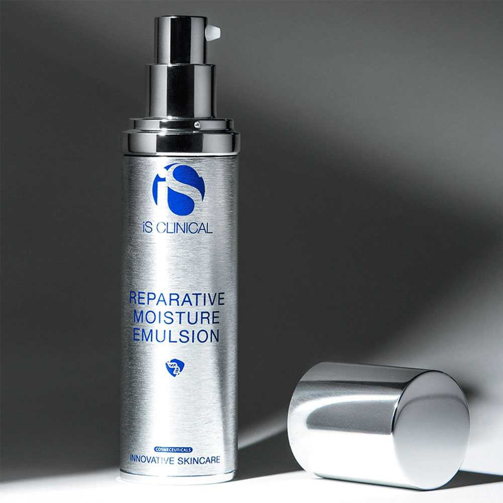 iS Clinical Reparative Moisture Emulsion bottle with cap off on gray background
