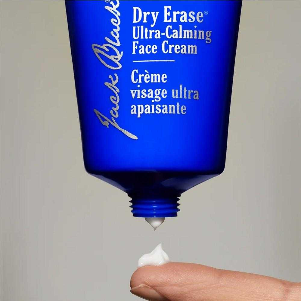 Jack Black Dry Erase tube squeezing cream onto a fingertip