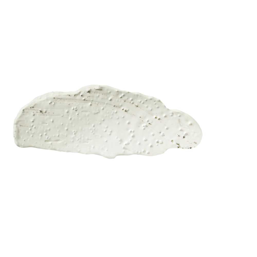 Swipe of pale green mask with visible flecks