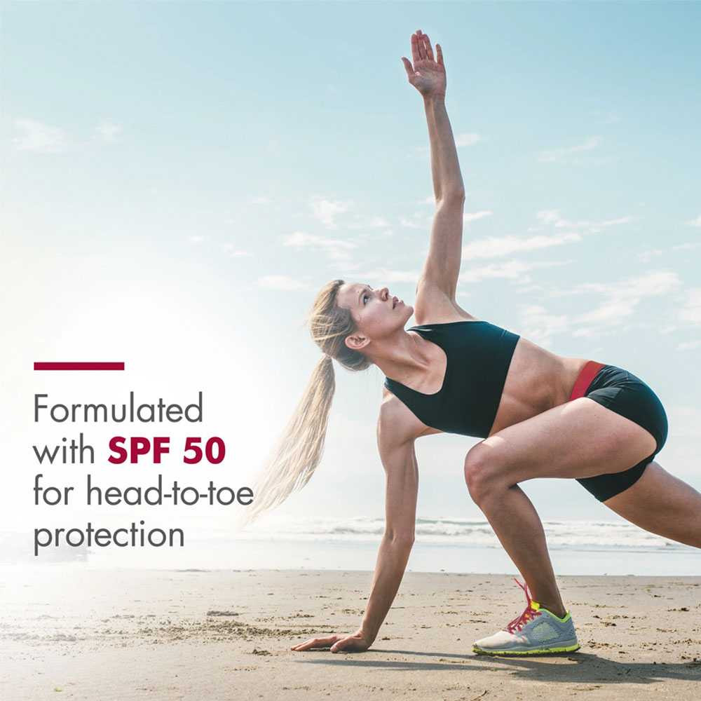 Woman stretching on a beach, formulated with SPF 50 for head-to-toe protection