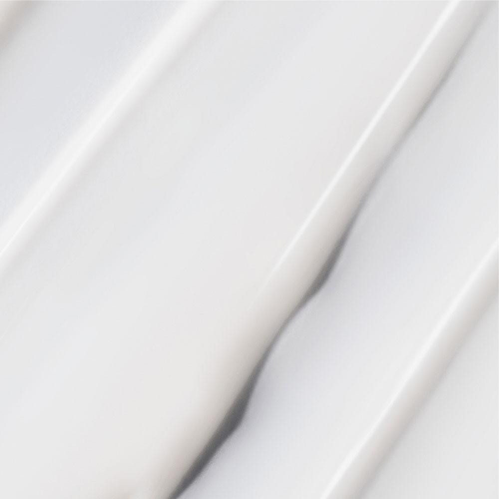 Close-up of glossy white serum swirls
