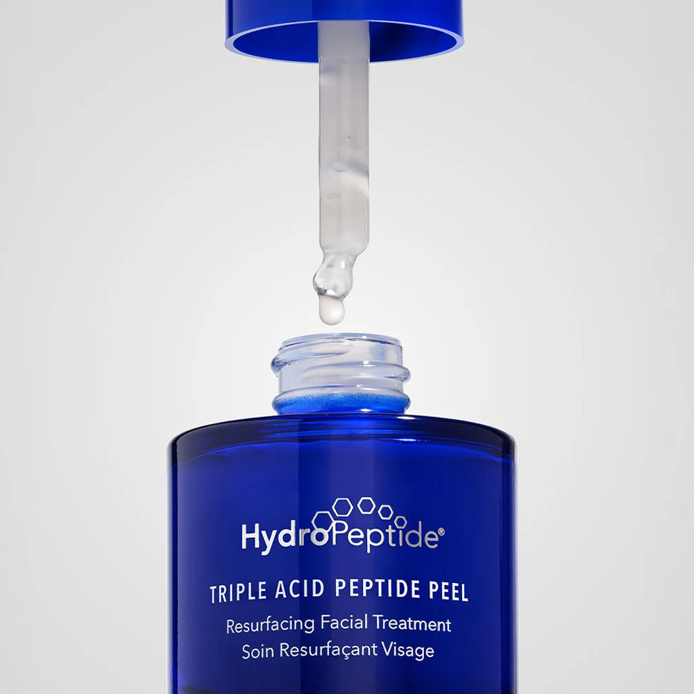 Dropper above the open Triple Acid Peptide Peel bottle