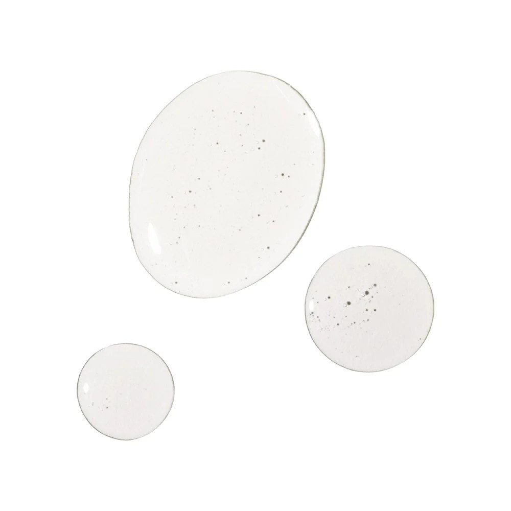 Clear oil droplets on a white surface