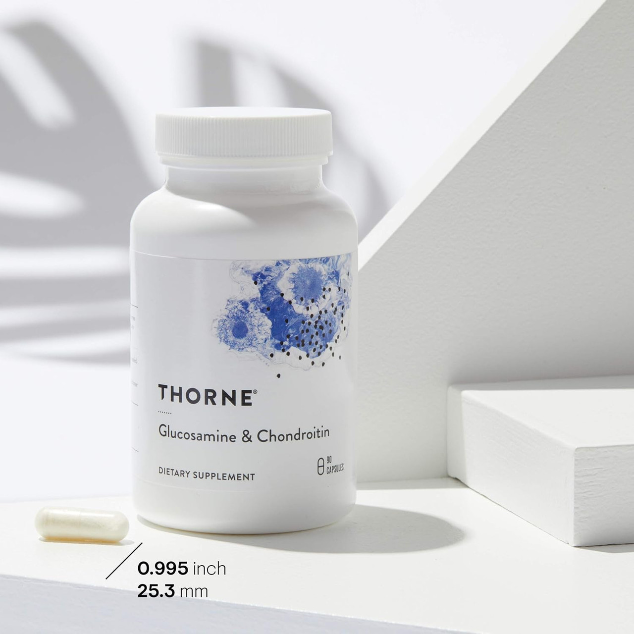 Thorne Glucosamine & Chondroitin bottle on a white plinth with capsule size