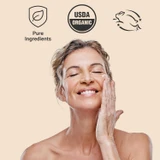 Smiling woman touching her face with pure ingredients, USDA Organic and cruelty-free icons