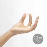 Hand holding a Marine Collagen tablet shown at 2.2 cm for size reference