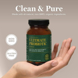 Hand holding Ultimate Probiotic bottle with non-GMO and gluten-free badges