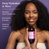 Smiling woman holding a castor oil bottle, deep hydration graphic