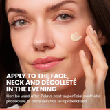 Woman applying cream to her cheek with evening use directions