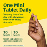 Hand holding mini tablet, one mini tablet daily, 30 tablets, 30 servings