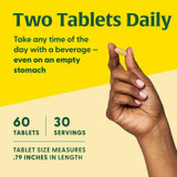Hand holding tablet, two tablets daily, 60 tablets, 30 servings