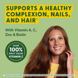 Smiling woman, supports a healthy complexion, nails and hair