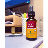 Herb Pharm Holy Basil bottle on a desk near a laptop
