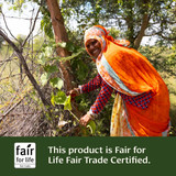 Woman harvesting leaves, this product is Fair for Life Fair Trade Certified