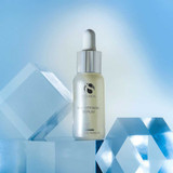 iS Clinical Brightening Serum bottle among clear blue glass blocks