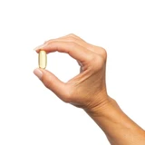Hand holding a fish oil softgel