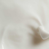 Swirl of white Oligomer Well-Being moisturizing body cream texture