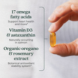 Hand holding golden Wholemega softgel, 17 omegas Vitamin D3 astaxanthin callouts