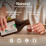 Hand pouring Calcium Magnesium, 180 mg magnesium 150 mg calcium per serving graphic