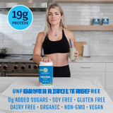 Woman in a kitchen with a shake and the tub, 19 g protein, 0 g added sugars, soy, gluten and dairy free