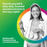 Smiling pregnant woman holding baby shoes, Rainbow Light prenatal nutrients in one easy caplet