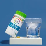 Men's One bottle and tablet on pedestal beside glass of water product shot