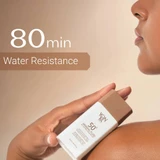 Hand holding the bottle against skin, 80 min water resistance graphic