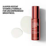 Vitamin C serum bottle with drops of serum