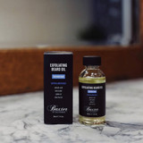 Baxter Exfoliating Beard Oil bottle and box on marble bathroom counter